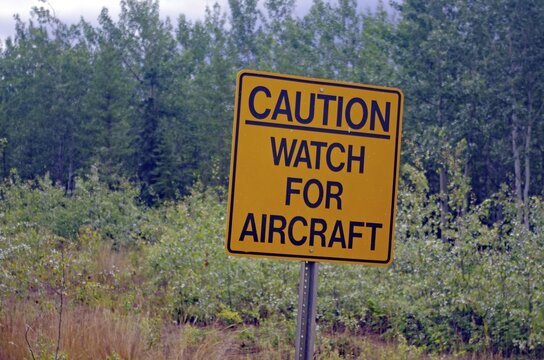 Sign warning of aircraft on the road, Wilderness, Alaska, USA