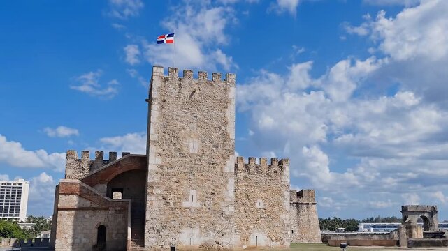 Historic Fortress Tower Under Blue Sky Dominican Republic Flag