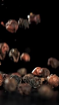 Black pepper falls on the table. Filmed on a high-speed camera at 1000 fps. High quality FullHD footage