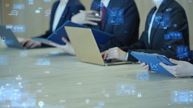 A group of male and female business professionals in a meeting and the concept of digital technology.