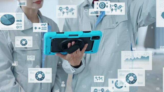 タブレットを見る男女エンジニアのグループとデジタルデータのコンセプト