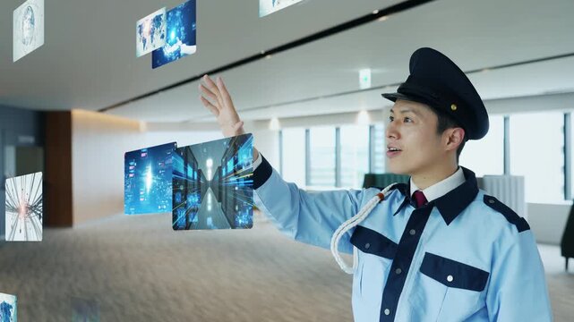 オフィスで立体映像をを見る男性警備員