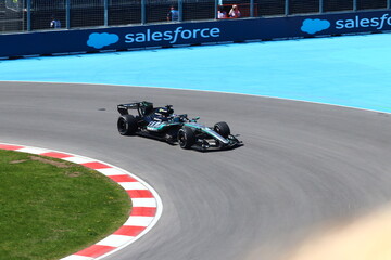 Obraz premium May 24, 2026, Montreal, Canada, Mercedes F1 car racing through Circuit Gilles Villeneuve corner. g.