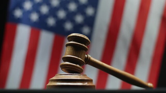 Judges Gavel On Block With Waving American Flag Background