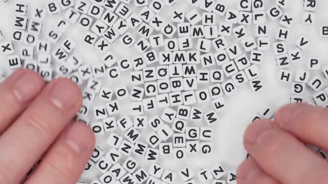 Closeup Hands Mixing White Alphabet Letter Cubes Randomly