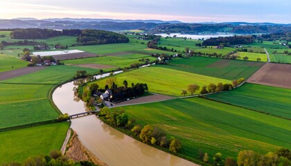 Fototapeta premium aerial view of a river running through a green landscape.