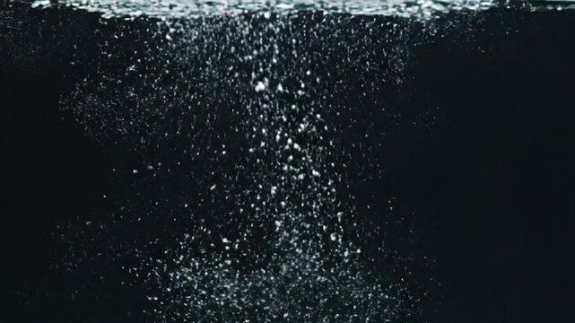 Clear water bubbles rising against a dark background.