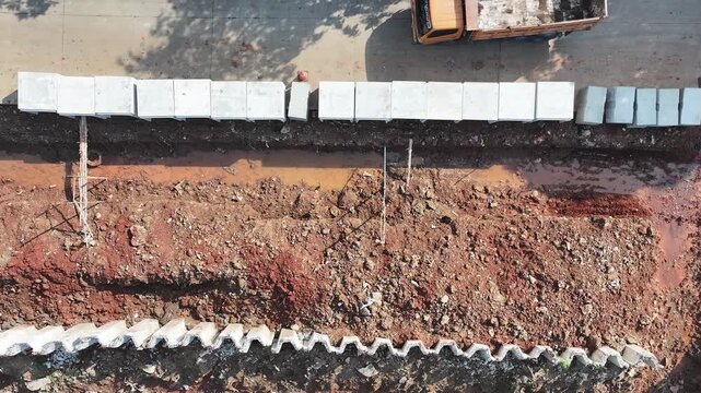 dredging mud on the riverbank in densely populated areas in the city center using heavy equipment such as excavators and dump trucks