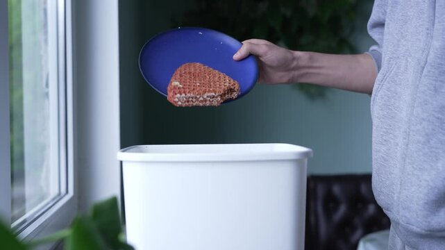 Food waste concept: uneaten cake disposal at home
