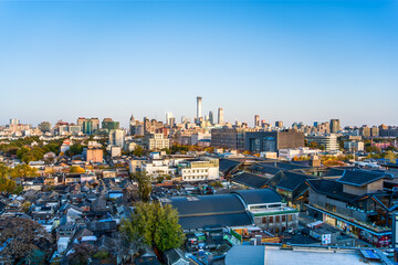 Fototapeta premium Aerial panoramic view of the blend of old and new skyline in Beijing's old city hutongs and CBD business district.