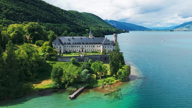 Aerial shot above Hautecombe Royal Abbey on the shores of Lac du Bourget on a suny day of spring in Savoie departement, Auvergne Rhone Alpes region, France