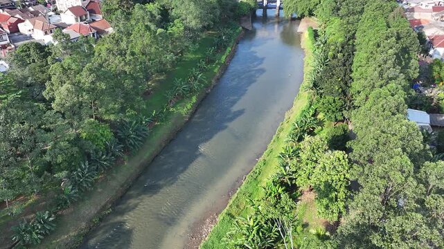dredging mud on the riverbank in densely populated areas in the city center using heavy equipment such as excavators and dump trucks