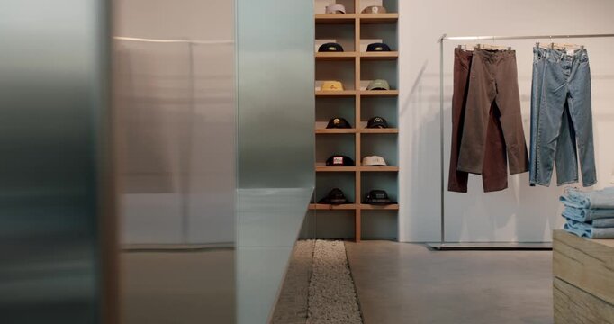 Modern clothing store with trendy jeans, pants, and a variety of stylish baseball caps displayed on shelves and racks. creating a sleek and contemporary shopping experience.