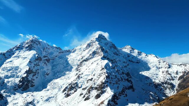 Majestic Snow Capped Mountain Peaks Under Clear Blue Sky