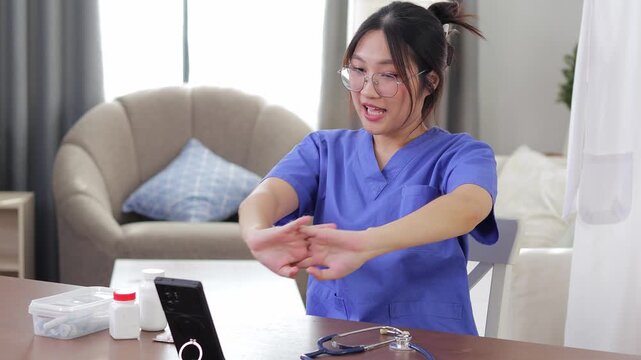 A young female doctor demonstrating physical stretching exercises during a live stream to educate viewers about preventing office syndrome and staying healthy.