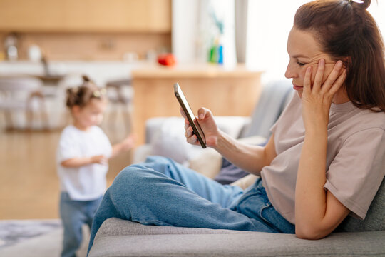 Female using smartphone at home internet watching videos, social networks