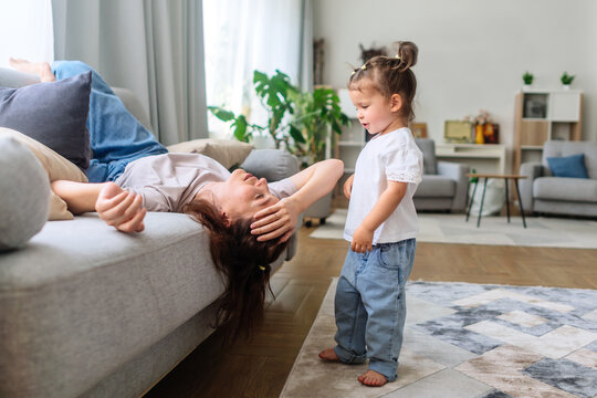 Tired mother lacks energy, lying down and exhausted