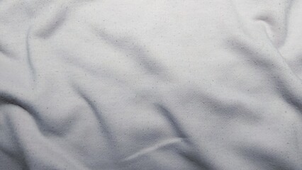 Obraz premium ​High-angle view of wrinkled white fabric texture with subtle pilling