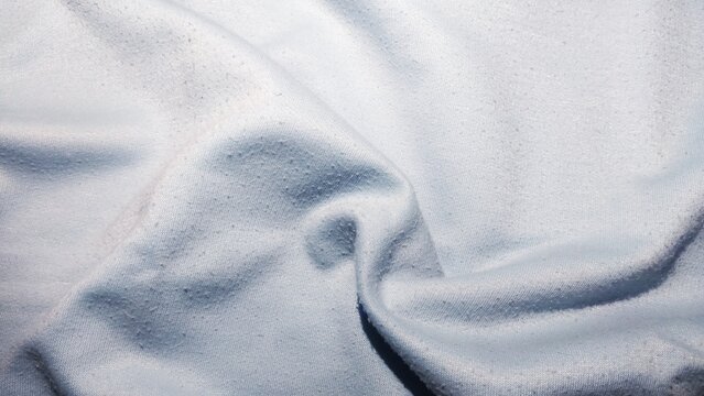 ​Close-up of light blue fabric texture with pilling background
