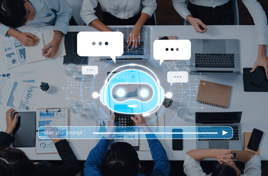A top-down view of a business meeting showcasing professionals engaging in discussion while utilizing digital tools, enhanced by an AI chatbot interface for improved collaboration. Trope