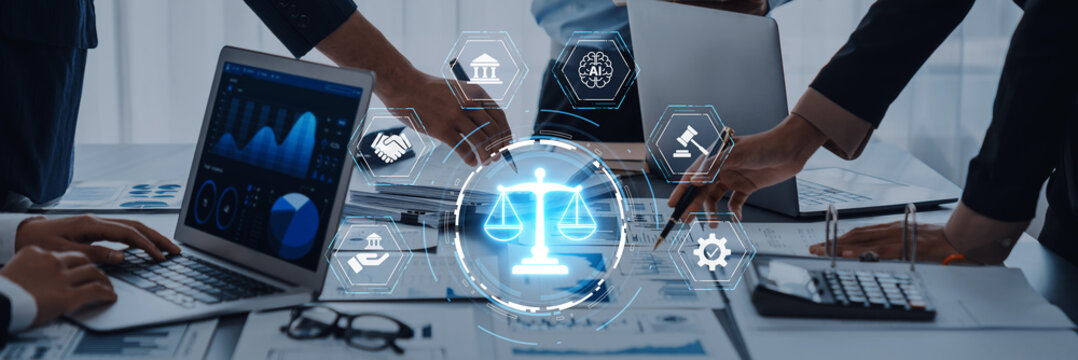 Team of professionals engaged in financial analysis using laptops and a digital law scales icon, symbolizing balance and legal compliance in a dynamic office setting. Trope