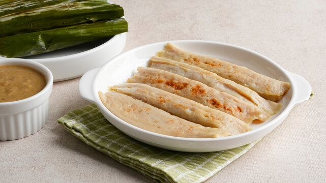 Otak-otak Tengiri, made from fish and flour covered with banana leaf. Served with peanut sauce. Indonesian food