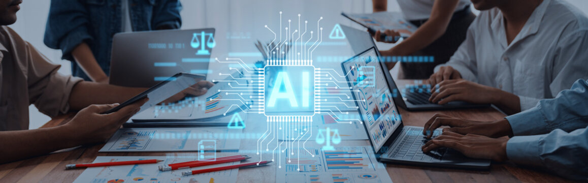 A dynamic scene depicting business professionals engaging with laptops and innovative AI graphics, showcasing the impact of technology on teamwork and productivity in the modern workplace. Trope