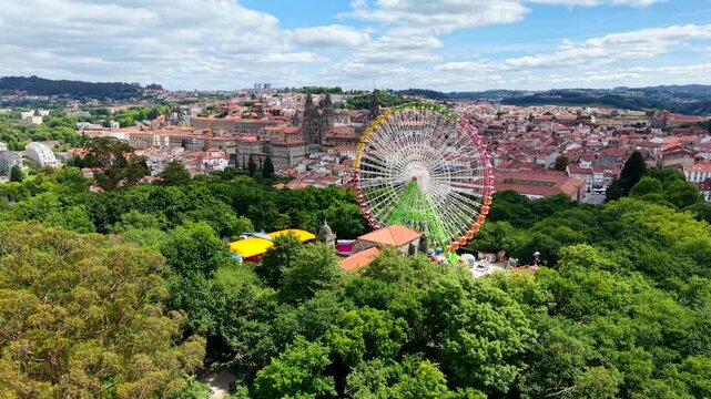 4K Drone shot of an empty, stationary 60-meter giant ferris wheel in La Alameda park, Santiago de Compostela. Cinematic daytime aerial view showing the massive metal structure
