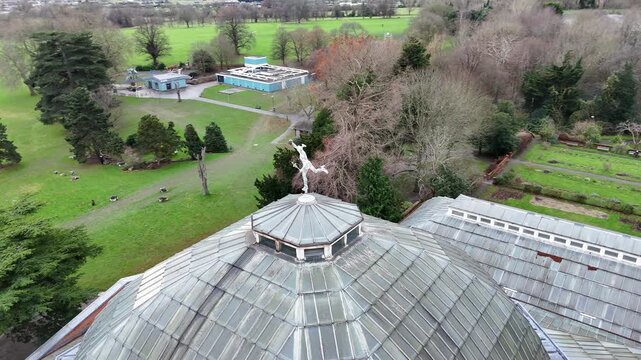 Drone orbit around the Hermes statue and glasshouse roof in Avery Hill Park, London.