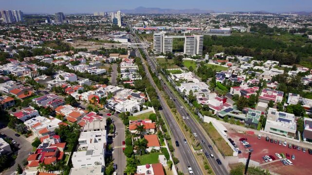 Drone shot flying over a modern boulevard in Andares neighborhood at daytime