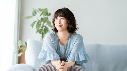 ソファでリラックスする笑顔の女性, Smiling Woman Relaxing on a Sofa