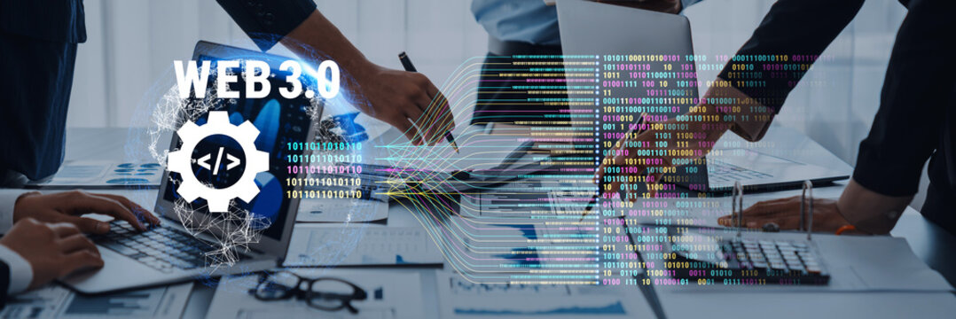 Hands collaborating on a laptop illustrates the concept of Web 3.0, showcasing data codes and technology focused on innovation, collaboration, and digital transformation. Trope