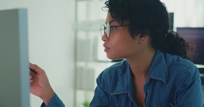 Young professional African American female programmer coding AI software on screens in modern home office. Generative AI, machine learning, digital innovation, future technology, online job concept.