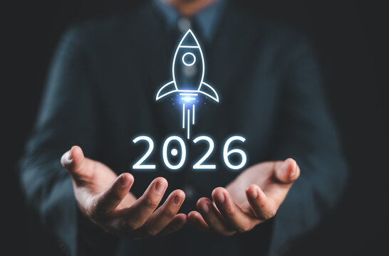 Businessman presenting 2026 with rocket launch icon, representing future vision, startup success, innovation, business planning, and new opportunities for the upcoming year.