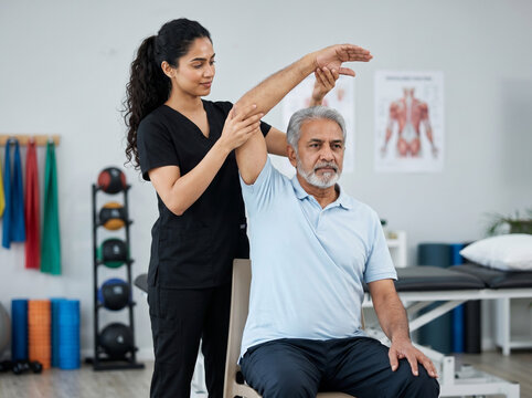 senior indian man receiving arm mobility physiotherapy treatment for rehabilitation recovery flexibility and orthopedic healthcare concept