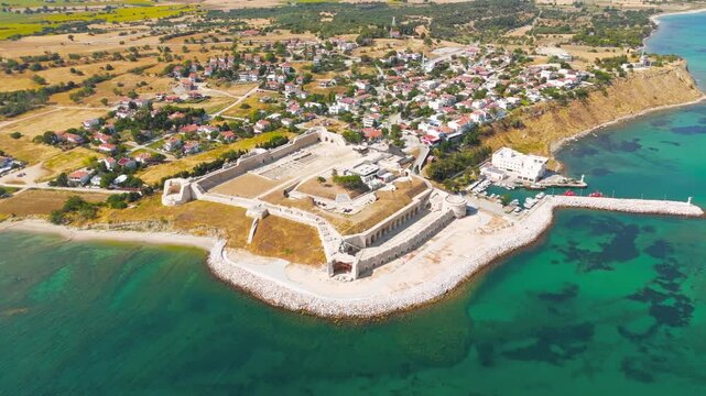 Seddulbahir, Eceabat, Turkey. Sedd el Bahr Fortress, angular stone bastions and earthworks, aerial view over turquoise Dardanelles waters and coastal village under bright summer sun. Aerial View, Mas