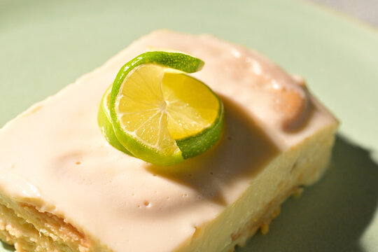 Homemade key lime pie square with elegant lime twist decoration