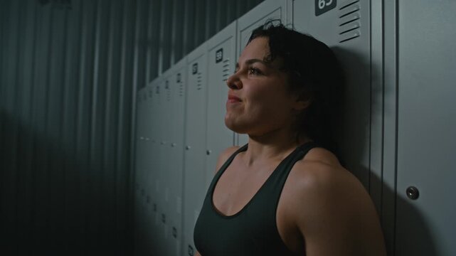 Close up of Woman Showing Raw Emotion and Confusion. Young Female Seen Trouble Breathing and Looking Around in Despair and Drinks Water, Trying to Calm Down. Concept of Hidden Struggles in Sport.