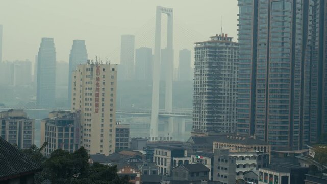 Chongqing Dense Urban Skyline with Cable Stayed Bridge and Yangtze River in Heavy Haze Daytime