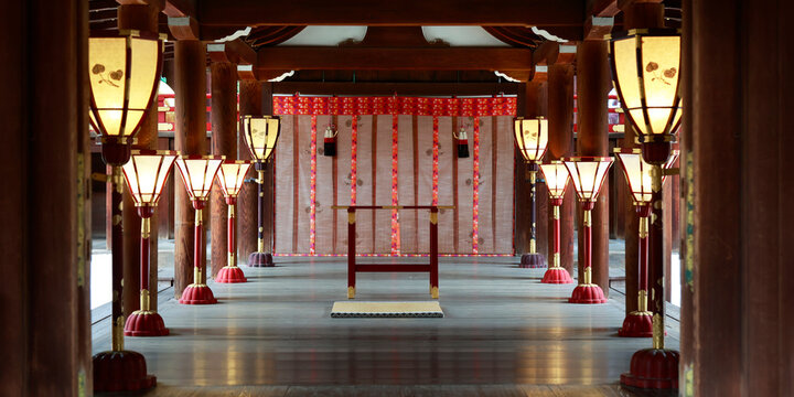 Interior of main hall with illuminated lanterns and ceremonial curtain at Kamigamo shrine, Kyoto, Japan