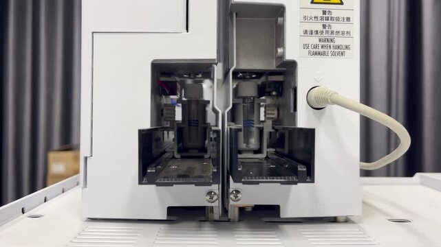 Gas chromatography autosampler performing syringe cleaning at the injection port before automated sample injection in an analytical laboratory environment