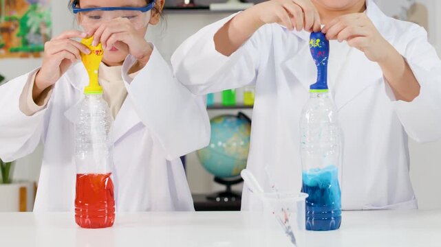 Excited Children in Lab Coats Performing Chemical Reaction Foam Explosion Experiment
