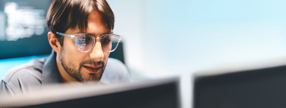 Close-up latin man tech engineering programmer eyeglasses with reflections computer machine learning code on the lenses