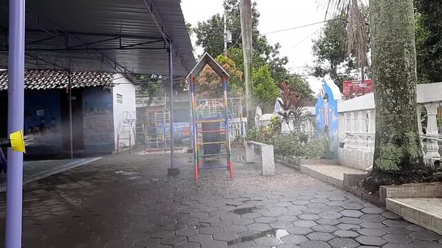 Spraying Disinfectant Mist in an Empty Kindergarten Playground
