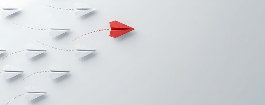 Red paper airplane leads a group of white paper airplanes on a path, symbolizing leadership, innovation, and distinctiveness against a clean background.