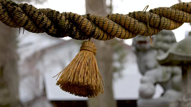 Close Up of Traditional Shinto Shimenawa Sacred Rope at a Japanese Shrine