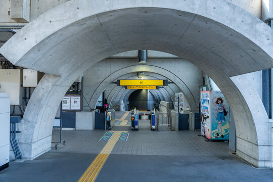 Uji Station, Kyoto, Japan - April 08, 2026 - Modern brutalist concrete architecture interior of Uji Station in Kyoto, Japan, featuring geometric arches, circular cutouts, skylights, escalators