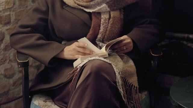 Enjoying a book while seated in a cozy cafe