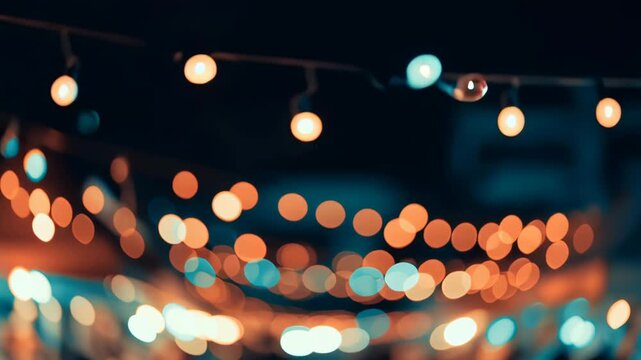 Vibrant blurred string lights glowing over crowds at a lively night market creating a festive bokeh background.