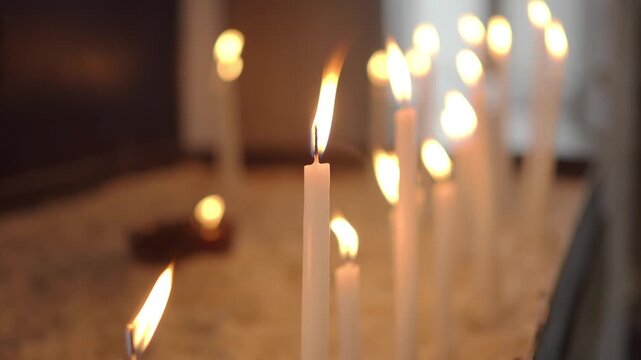 Candles burn softly in a quiet place for reflection